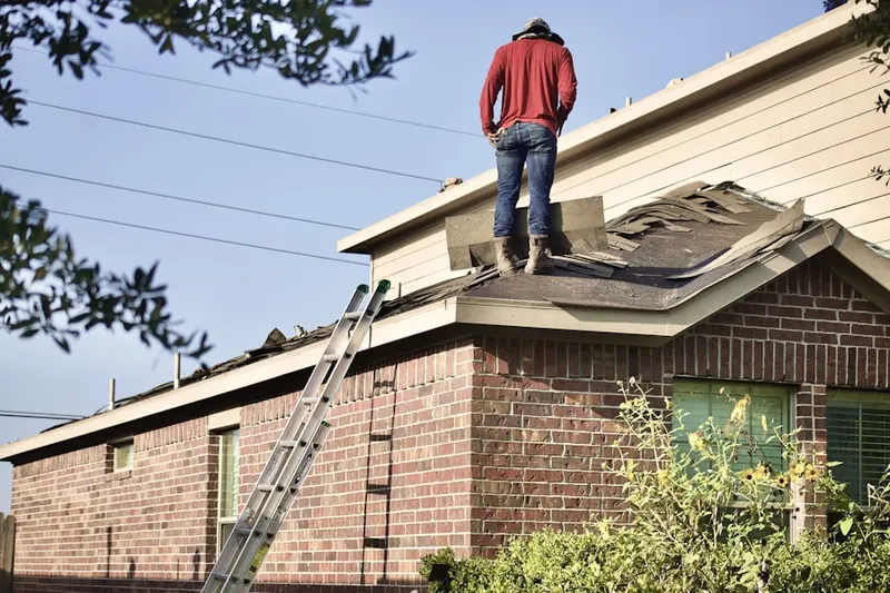 Professional roofer working on a residential roof in Pratt Corners
